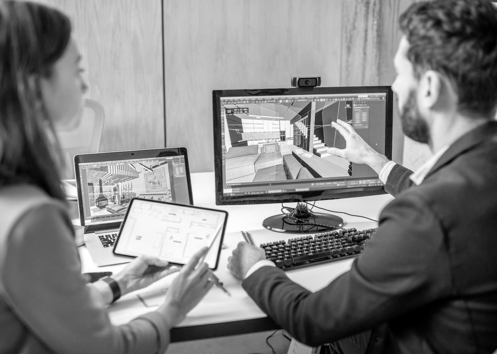 Two people reviewing a 3D rendered design, contact us for more information about Viinplan